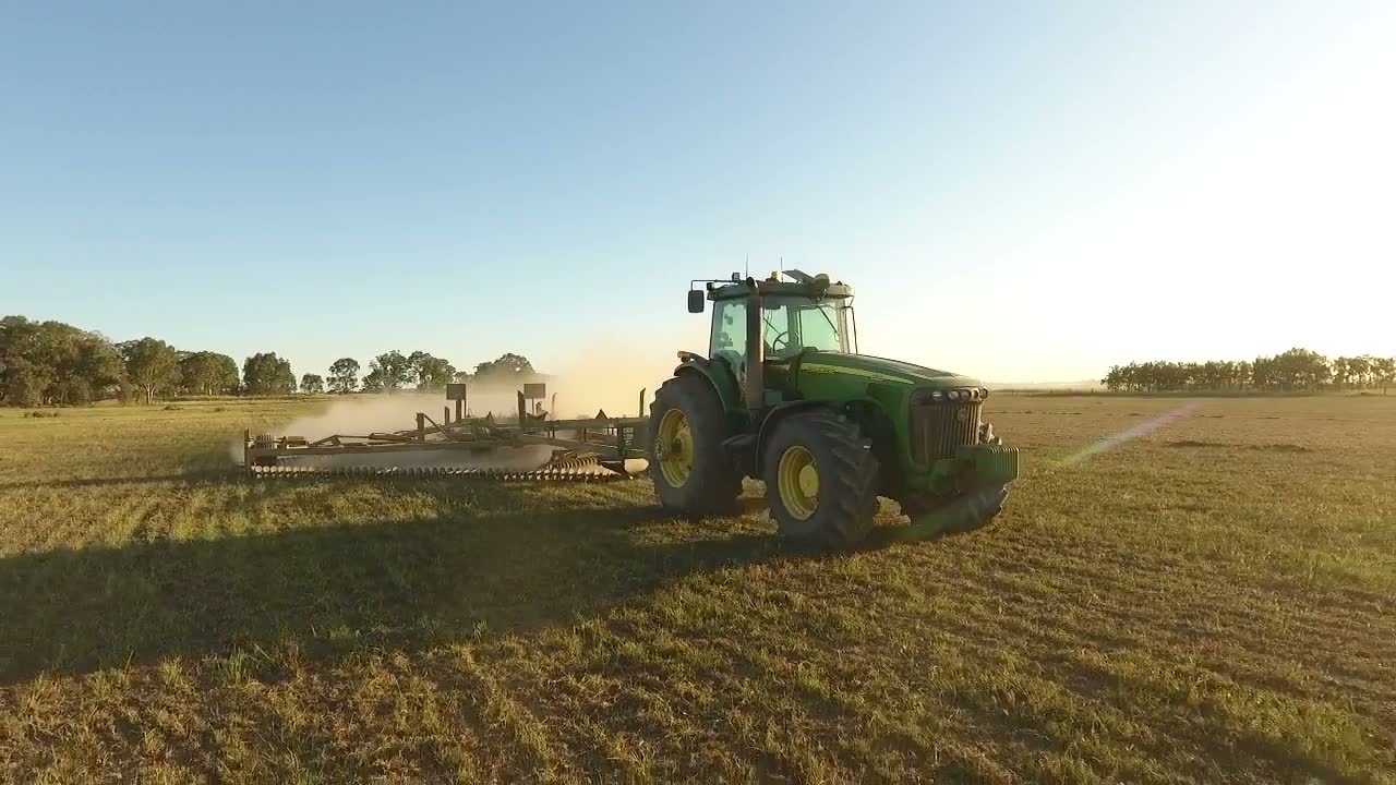Ornata-operated John Deere tractor working a field